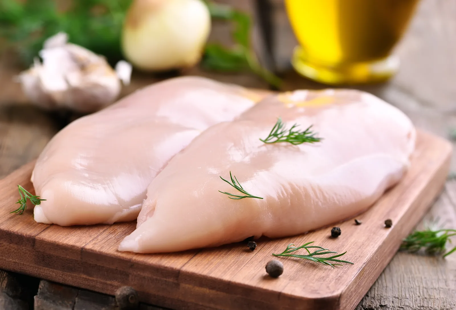 Raw chicken breast fillets of the kind inspected on a poultry packing line